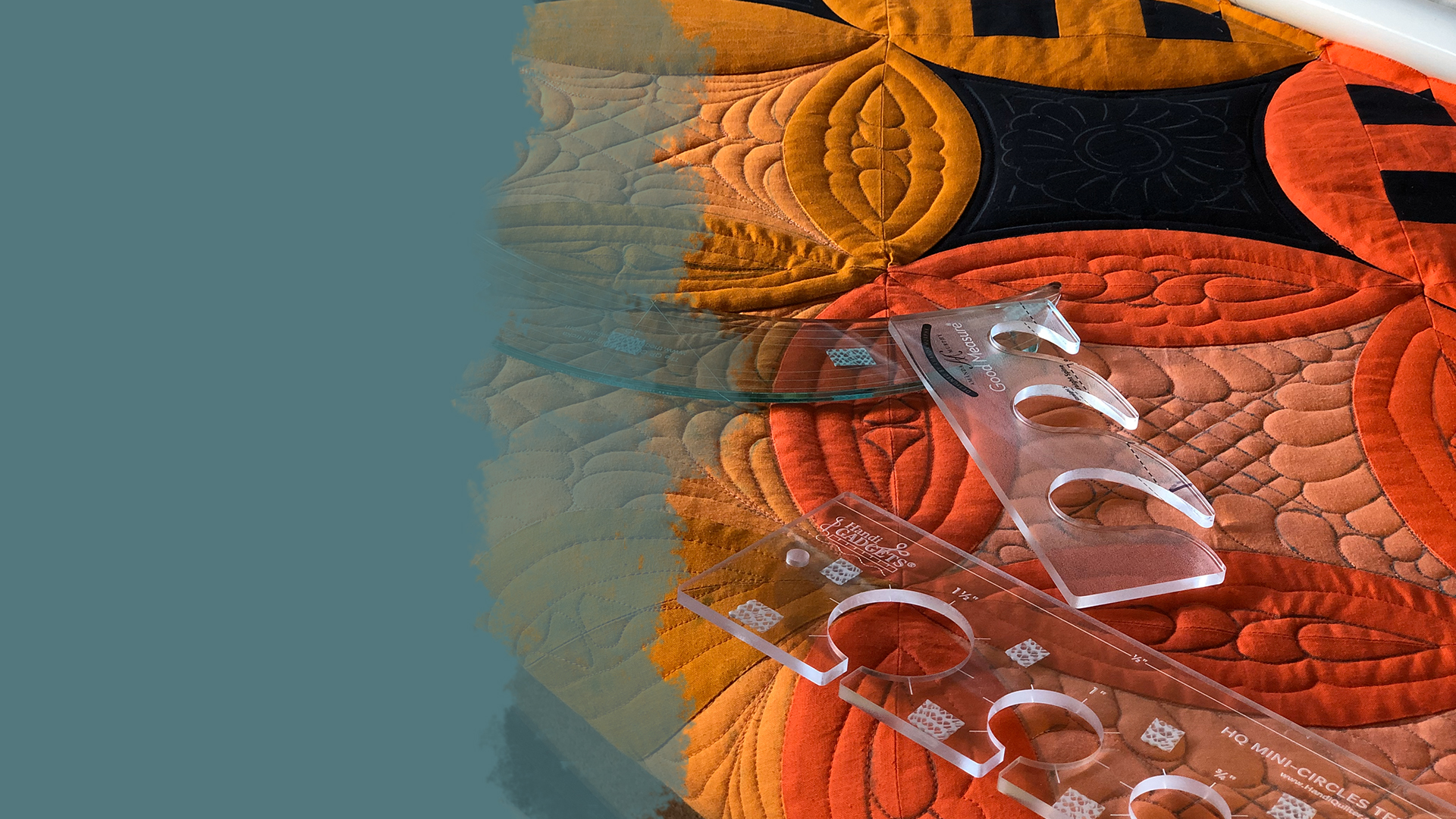 Orange and yellow section of the surfing through rainbows quilt loaded on the longarm with three longarm quilting rulers