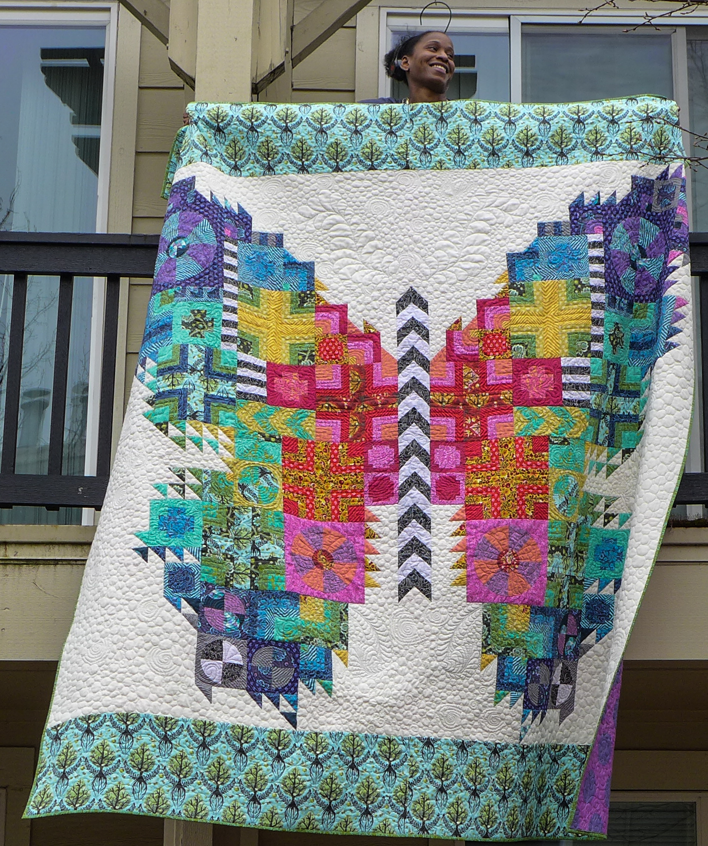 Tula Pink Butterfly quilt is finished in rainbow fabrics with detailed free motion quilting.